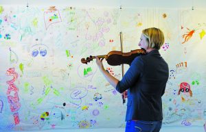Musician playing the visitor-created graphic score.