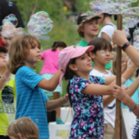 Children blowing large bubbles