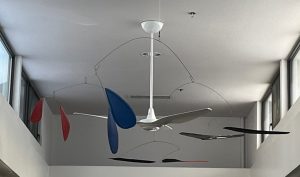 Red, blue and black mobile hanging near the ceiling at the Reynolds Branch Library