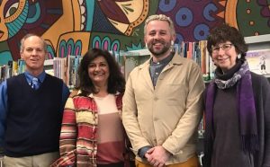 2023 Library Commissioners are gathered in front of the George Reynolds Branch children's space mural. Image depicts (left to right): Scott Steinbrecher, Benita Duran, Steven Frost, and Miriam Gilbert. 
