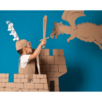 child with a cardboard sword fighting a cardboard dragon in a cardboard castle.