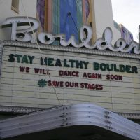Boulder Theater marquee reading "Stay Healthy Boulder"