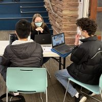 two students working with a national history day mentor