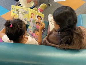 a child reading with a reading buddy