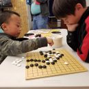 2 children playing a game of Go