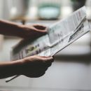 Image of hands holding a newspaper