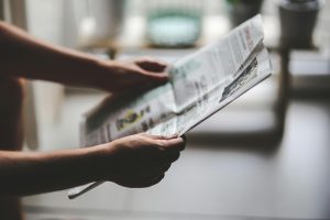 Image of hands holding a newspaper