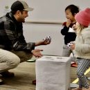 an adult showing a young child a toy ball